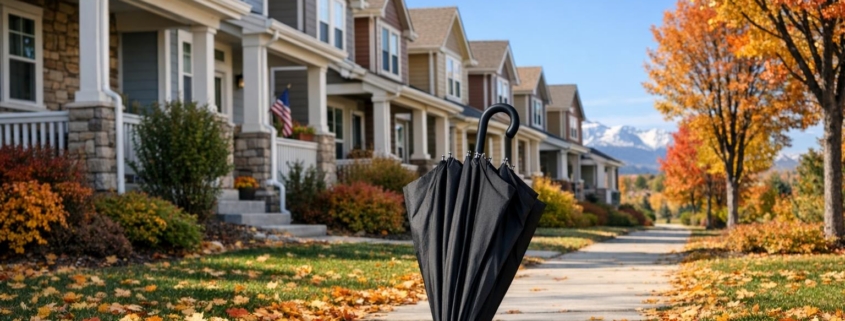 Autumn scene with well-kept Colorado rental homes and a closed umbrella on the walkway, illustrating insurance protection for property owners.